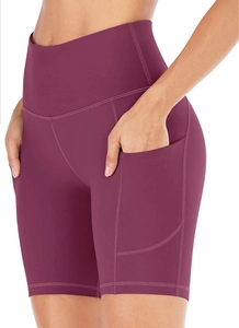 Detail view of high waisted plum yoga shorts featuring side pockets and reinforced seams