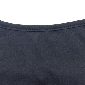 Detailed macro shot of high-density black knitted fabric with reinforced double stitching
