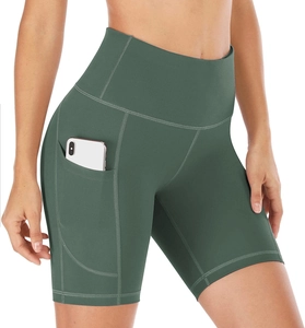 Detail view of high-waisted dark green yoga shorts with practical side pocket design