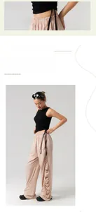 Dettaglio ravvicinato di un top nero a costine con coulisse e pantaloni rosa a gamba larga