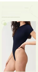 Detailed view of navy blue ribbed knit bodysuit with crew neck and slim fit texture