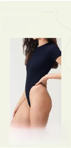 Detailed macro view of the navy blue ribbed fabric and soft breathable texture of the bodysuit