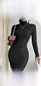 Détail du tissu de la robe noire moulante et de l'accessoire collier chaîne dorée