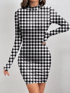 Close-up of the classic black and white houndstooth pattern on a slim-fit mini dress