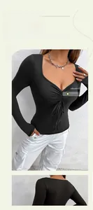 Detailed view of black V-neck top with front ruched drawstring and ribbed knit texture