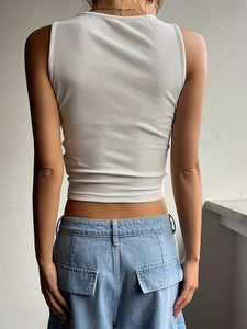 Back view of a white ribbed knit crop top paired with high-waisted jeans in Y2K style