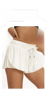 Detail of white double-layer sports skirt with high waist, drawstring and breathable fabric