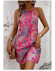 Close-up detail of paisley printed boho halter dress with vibrant pink and teal patterns