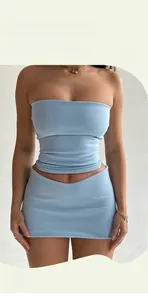 Detailed texture of light blue knitted fabric on a slim fit tube top and mini skirt set