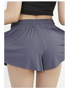 Detail view of high-waist elastic pleated waistband on breathable yoga sports shorts