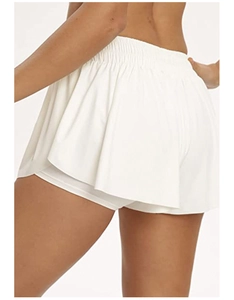 Macro shot of white high-waisted yoga skort with elastic waistband and double-layer fabric