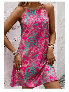 Close-up of pink paisley print on a halter neck satin sleeveless mini dress for summer