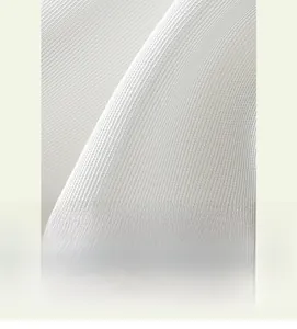 Macro shot of white ribbed knit fabric texture with vertical grain and soft feel