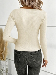 Rear view of beige ribbed knit sweater highlighting the slim fit and textured fabric