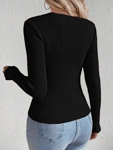 Close-up of black ribbed knit V-neck sweater showing slim fit and texture from the back