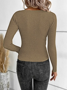 Close-up of khaki ribbed knit texture on the back of a long sleeve sweater top