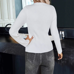 Detail view showing the ribbed knit texture and slim fit design of a white V-neck sweater