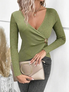 Detail of green ribbed knit sweater with wrap V-neck and decorative side waist buckle