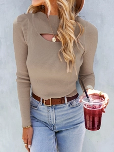 Close-up of the irregular hollow neckline on a tan ribbed knit sweater for women