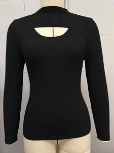 Detail of asymmetric cutout neckline on black ribbed knit long sleeve sweater