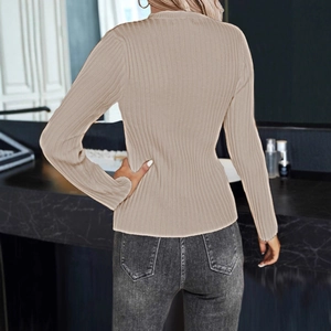 Detail view of beige ribbed knit sweater texture and slim fit from a back perspective