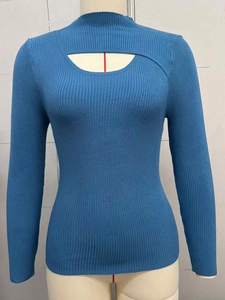 Detail of blue ribbed knit sweater with mock neck and cut-out chest design for women