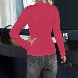 Detail of deep pink ribbed knit long sleeve sweater showing fabric texture and back fit