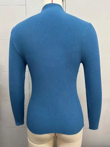 Detail view of teal high-neck ribbed knit sweater back on a mannequin display