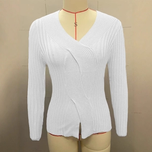 Close-up of white ribbed knit sweater with elegant twist knot V-neck design and side slits