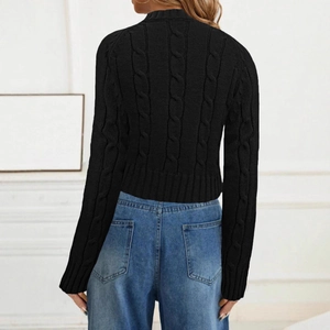 Back view of a black cable knit sweater showing detailed texture and ribbed hem