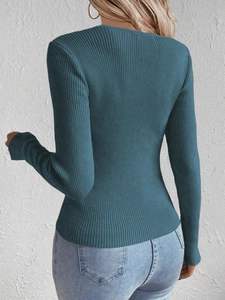 Detail of slim-fit rib-knit sweater in peacock blue with long sleeves and back texture