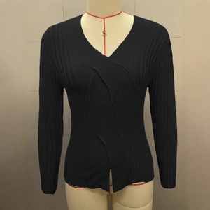 Detail of black V-neck ribbed knit sweater showing intricate crossover woven texture
