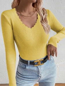 Detail of scalloped V-neckline on yellow ribbed knit long sleeve sweater for women