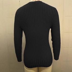 Detailed back view of slim fit black ribbed knit sweater with vertical texture on mannequin