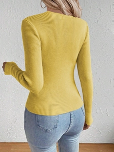 Back view of slim fit yellow ribbed knit sweater paired with light blue denim jeans