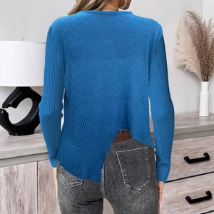 Détail de l'ourlet asymétrique et de la maille côtelée sur le pull bleu marine à manches