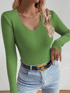 Detail of green V-neck ribbed knit sweater with unique wavy neckline and slim fit design