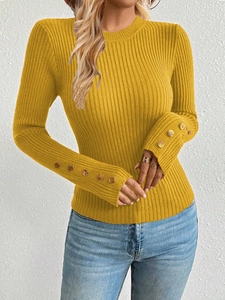 Close-up of yellow ribbed knit sweater featuring elegant gold button cuffs and slim fit texture
