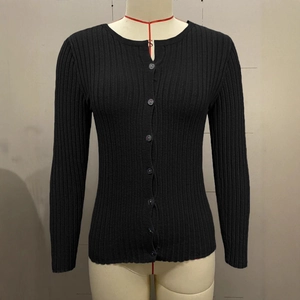 Close-up of black ribbed knit cardigan featuring button-front closure and fine texture