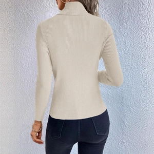 Detail view of the back of a beige ribbed knit turtleneck sweater with vertical texture