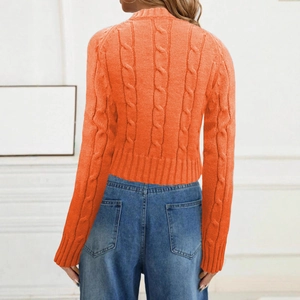 Detail of orange cable knit sweater back showing ribbed cuffs and texture