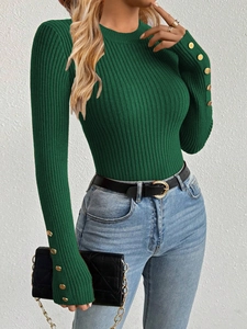 Detail of slim fit dark green ribbed knit sweater with golden button cuffs for women