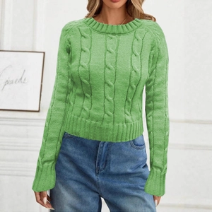Detail of the grass green cable knit pattern and crew neck on a women's long sleeve sweater