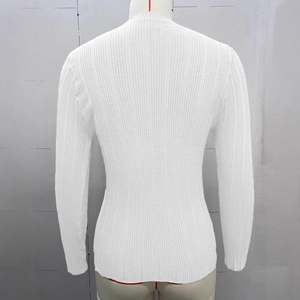 Close-up of white ribbed knit fabric texture and slim fit long sleeve design