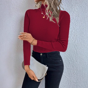 Close-up of wine red turtleneck sweater featuring vertical ribbed knit and slim fit texture
