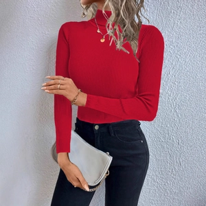Close-up of red turtleneck ribbed knit top showing fabric texture and slim fit design