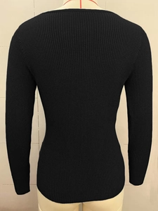 Rear view of slim fit black ribbed knit sweater with long sleeves on a mannequin