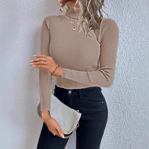 Detail of light brown ribbed turtleneck sweater with slim fit and knit texture