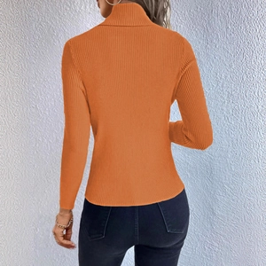 Back view of bright orange turtleneck knit sweater featuring vertical ribbed texture