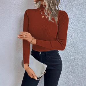 Close-up of the fine ribbed texture on this brick red turtleneck knit sweater top